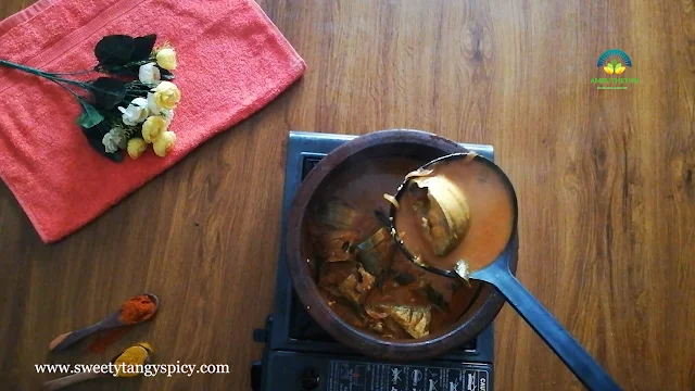 A pot of flavorful Thenga Paal Meen Curry resting and infusing with spices after simmering.