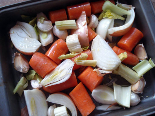 Place all the vegetables and garlic into the middle of a roasting tray