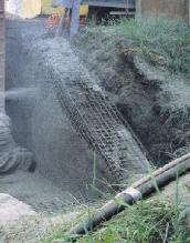 Silica-fume shot-crete being used for repair of deteriorated bridge abutment