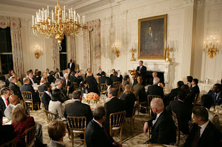 President George W. Bush welcomes guests to the Iftaar Dinner with Ambassadors and Muslim leaders in the State Dining Room of the White House, Thursday, Oct. 4, 2007. White House photo by Chris Greenberg.