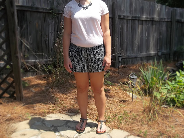  Pink lace tee, black and white patterned soft shorts, grey statement necklace, black sandals outfit outfit inspiration