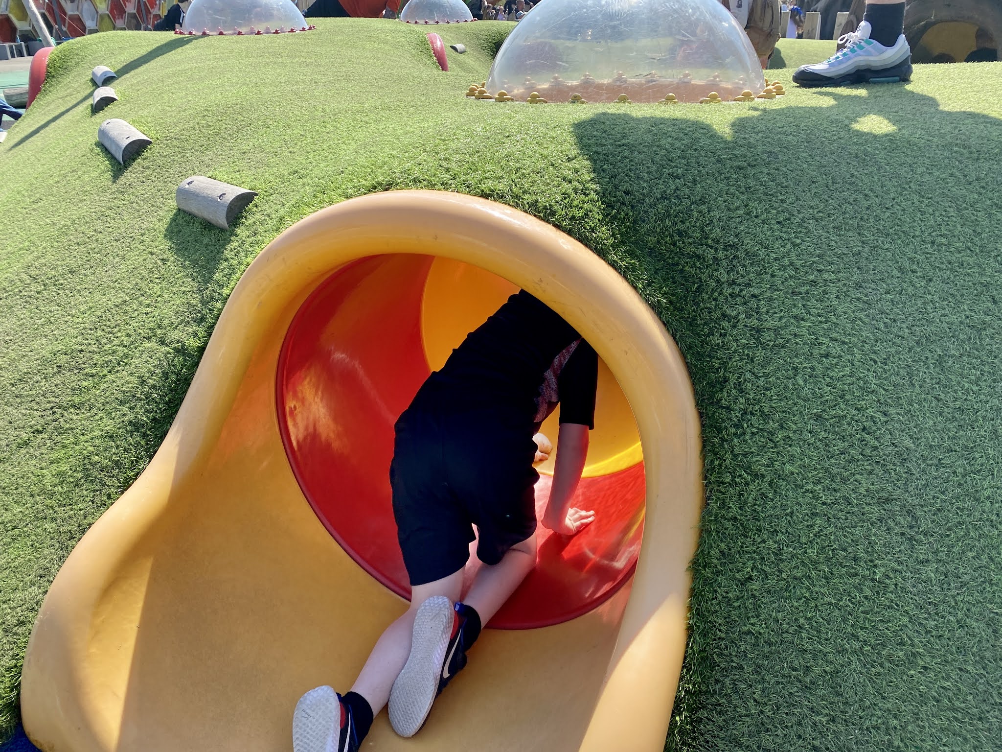 boy crawling through a tunnel