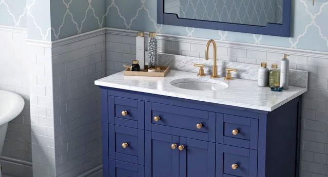Classic styling in deep blue, this vanity by Hardware Resources is a winner in this white and blue bathroom.