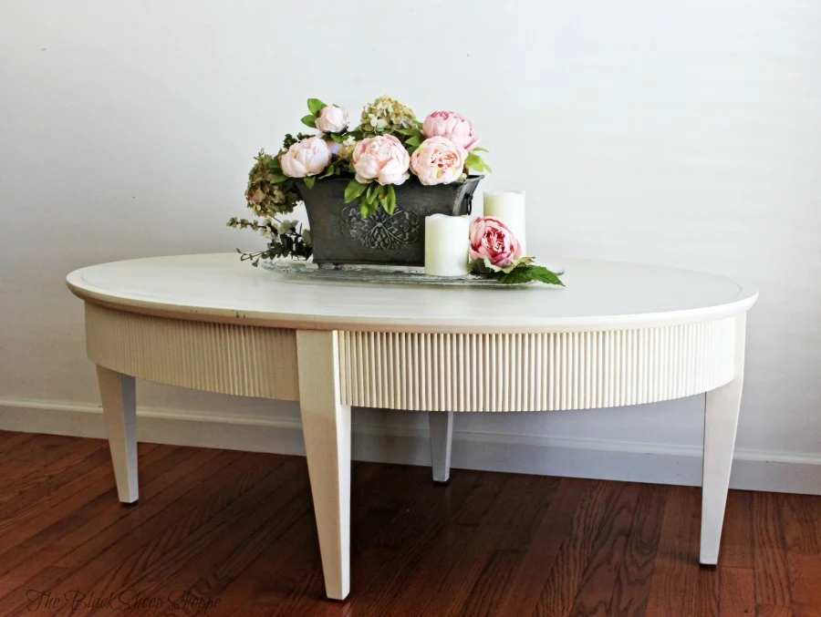 Side view of oval coffee table painted in Old White chalk paint.