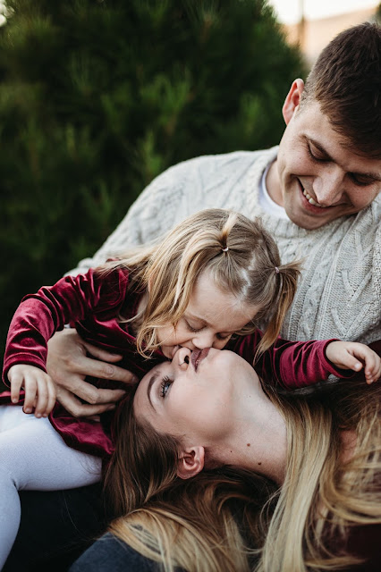 Daughter kissing mom at Holiday photo session in San Diego CA