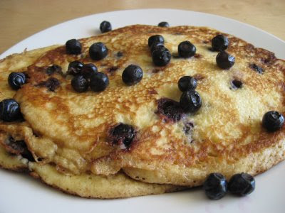 Serve pancakes warm with additional berries and maple syrup.