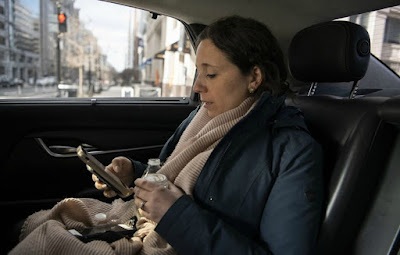 Julie Pace using her mobile phone sitting inside her car