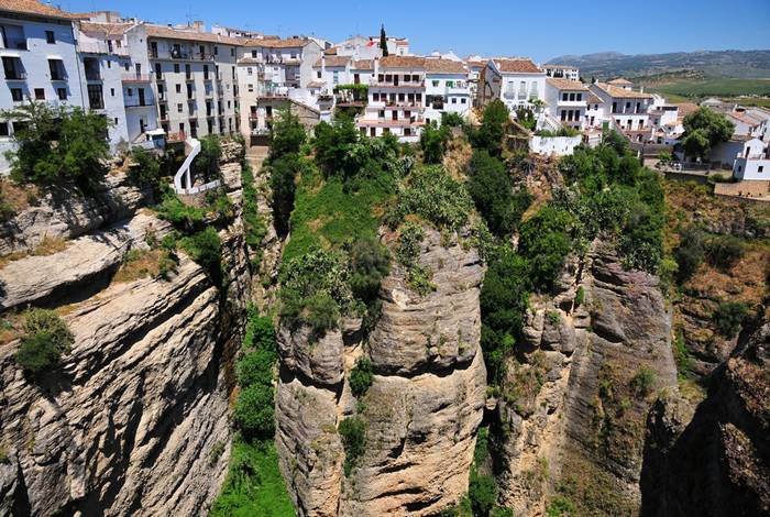 Ronda is a city in the Spanish province of Málaga. It is located about 100 kilometres (62 mi) west of the city of Málaga with a population of approximately 35,000 inhabitants. Ronda was first settled by the early Celts, who, in the 6th century BC, called it Arunda. Later Phoenician settlers established themselves nearby to found Acinipo, known locally as Ronda la Vieja, Arunda or Old Ronda. The current Ronda is however of Roman origins, having been founded as a fortified post in the Second Punic War, by Scipio Africanus