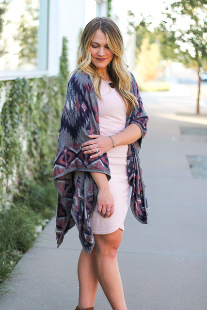 young woman styling a pink bodycon dress and poncho look