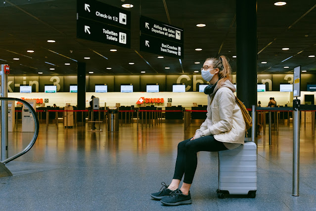 https://www.pexels.com/photo/woman-sitting-on-luggage-3943882/