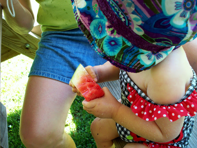 Baby girl eating watermelon