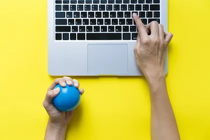 A professional woman using a stress ball while working
