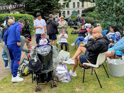Neighbours sit and chat in Tredegar Square at the Jamboree picnic