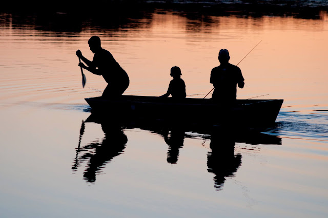 fishing at sunset, family in boat.Photo by Jed Owen on Unsplash