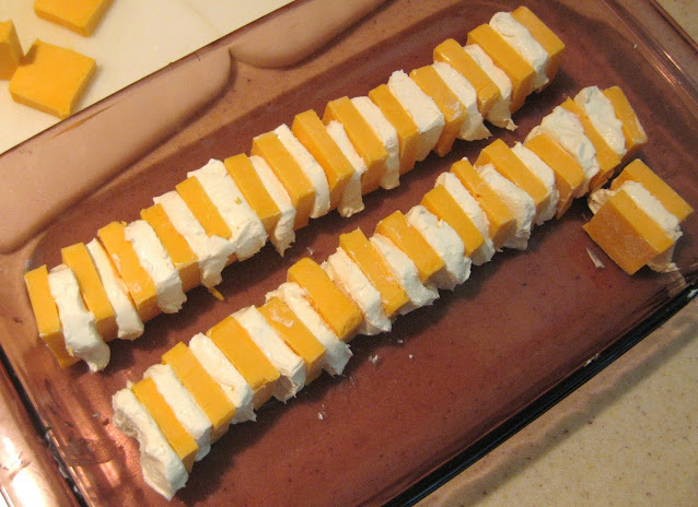 Placing cheese slices in an alternating pattern in a shallow dish image