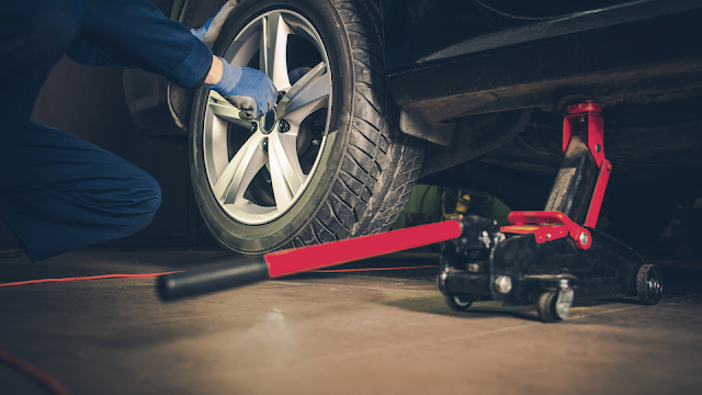 a mechanic doing tire rotation