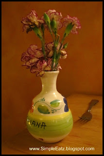 Pink carnations in a white vase