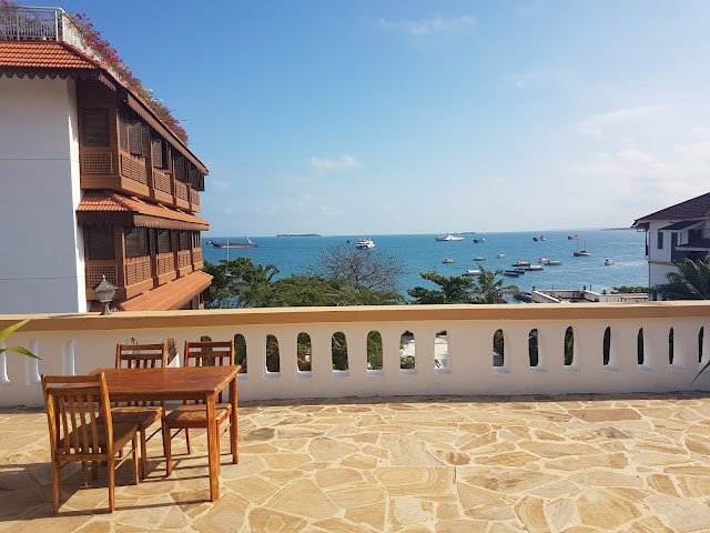 The ocean seen from across Abuso Inn's Rooftop Dining Area, in StoneTown, Zanzibar. To the left is the Park Hyatt