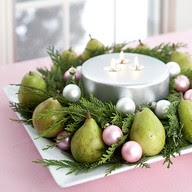 pears and pink ornaments with cedar and candle Christmas table