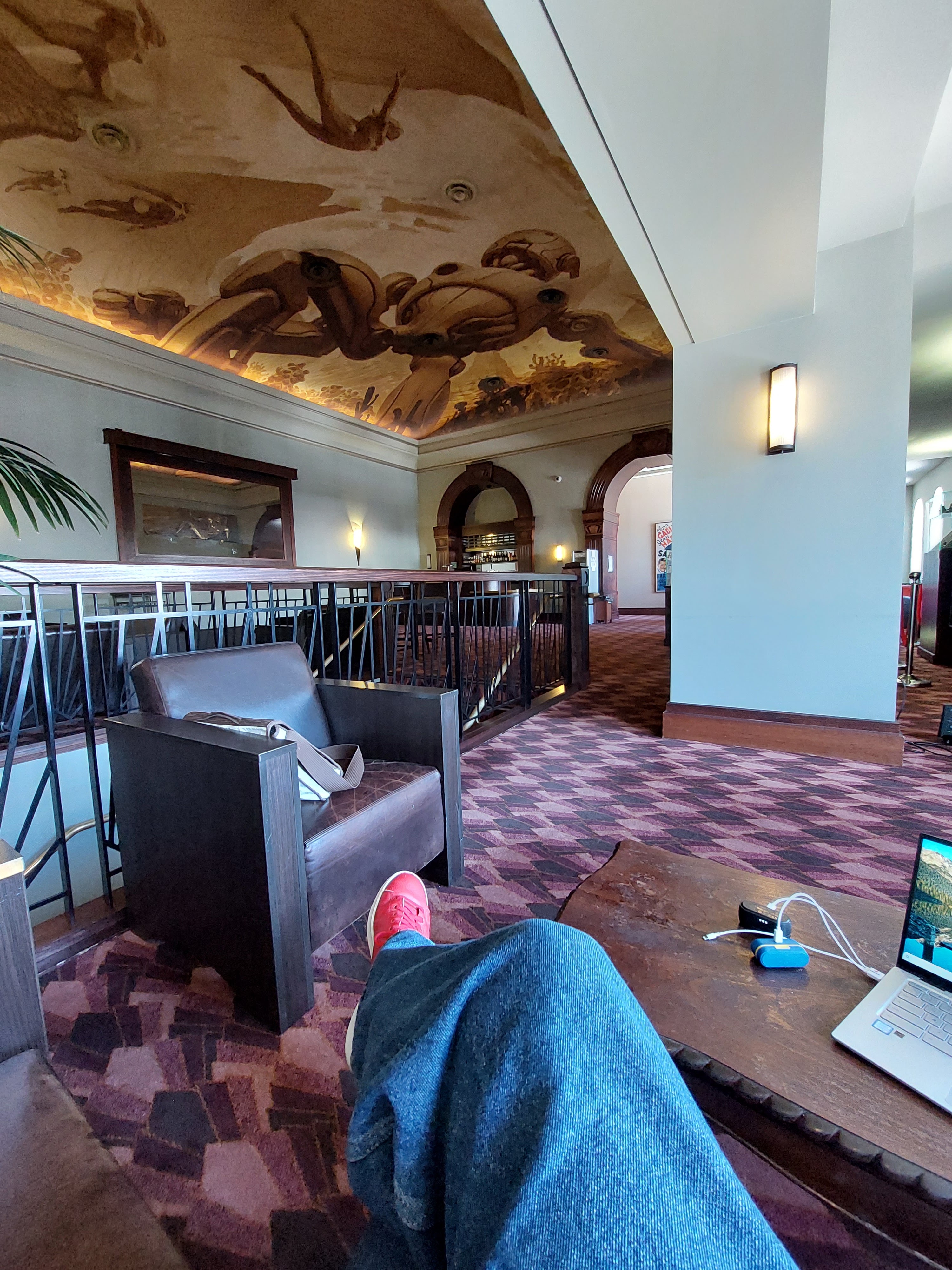 Upstairs bar at The Roxy cinema as taken from a seat in the corner highlighting the steampunk ceiling mural