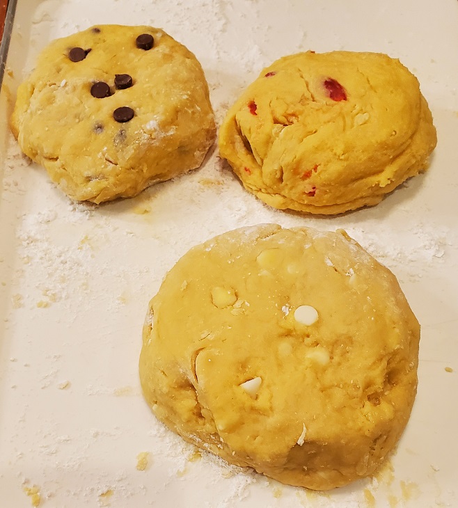 cookie dough mixed with chocolate chips, coconut, maraschino cherries in 3 different cookies dough flavors