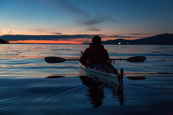 A canoeist on the water at night (Photo: stock image)