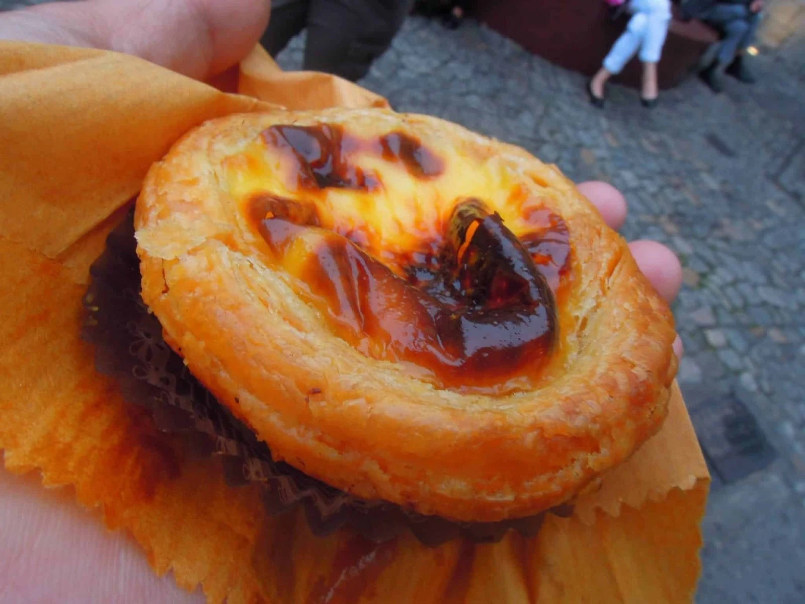 A close up photograph of an egg tart being sold in the streets in Macau