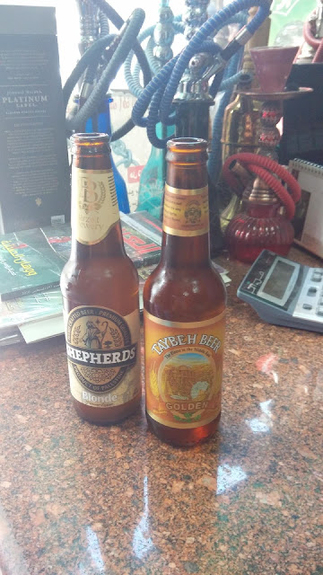 Sampling Palestinian beer in a convenience store in Jericho