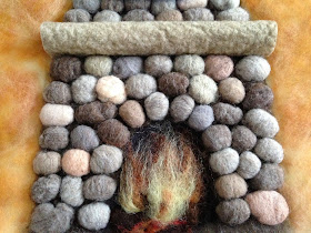 Miniature fireplace made of wool stones.