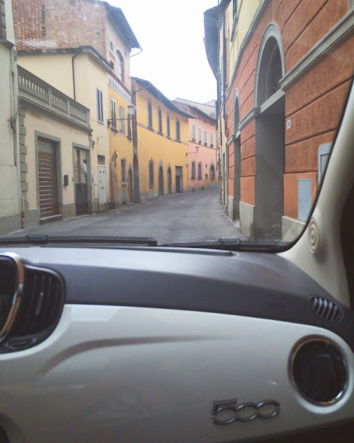 In Car View of Driving Through Streets of San Miniato in White Fiat 500