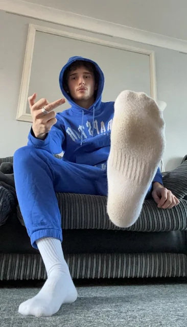 Blue Velvet tracksuit showing off bottom of white sock and give them the middle finger