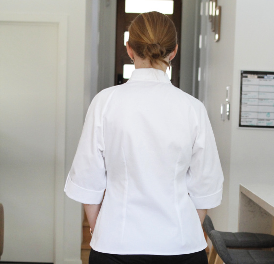 the back view of a woman wearing a white shirt