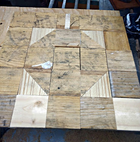 piece and glue pallet wood squares to a piece of plywood to make a fall quilt