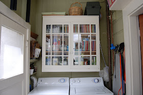 laundry area with cabinet, doors shut