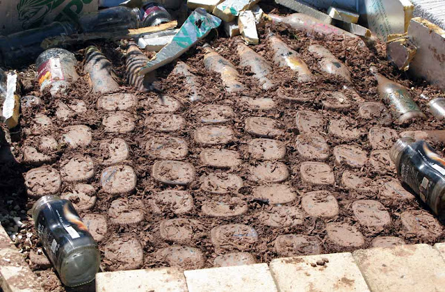 Empty bottles and jars are packed together with the insulation mix.