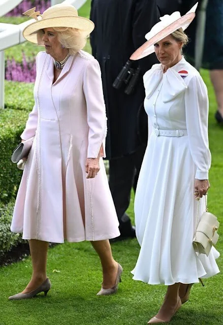 Zara Tindall wore a blue dress by Laura Green. Queen Camilla wore her Anna Valentine pink dress coat. Suzannah Allison dress