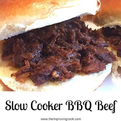 Close up of slow cooker BBQ beef in a soft white roll