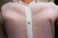 Pink bra under sheer white shirt.