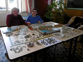 Doing a jigsaw at a community library.  Indre et Loire, France. Photographed by Susan Walter. Tour the Loire Valley with a classic car and a private guide.