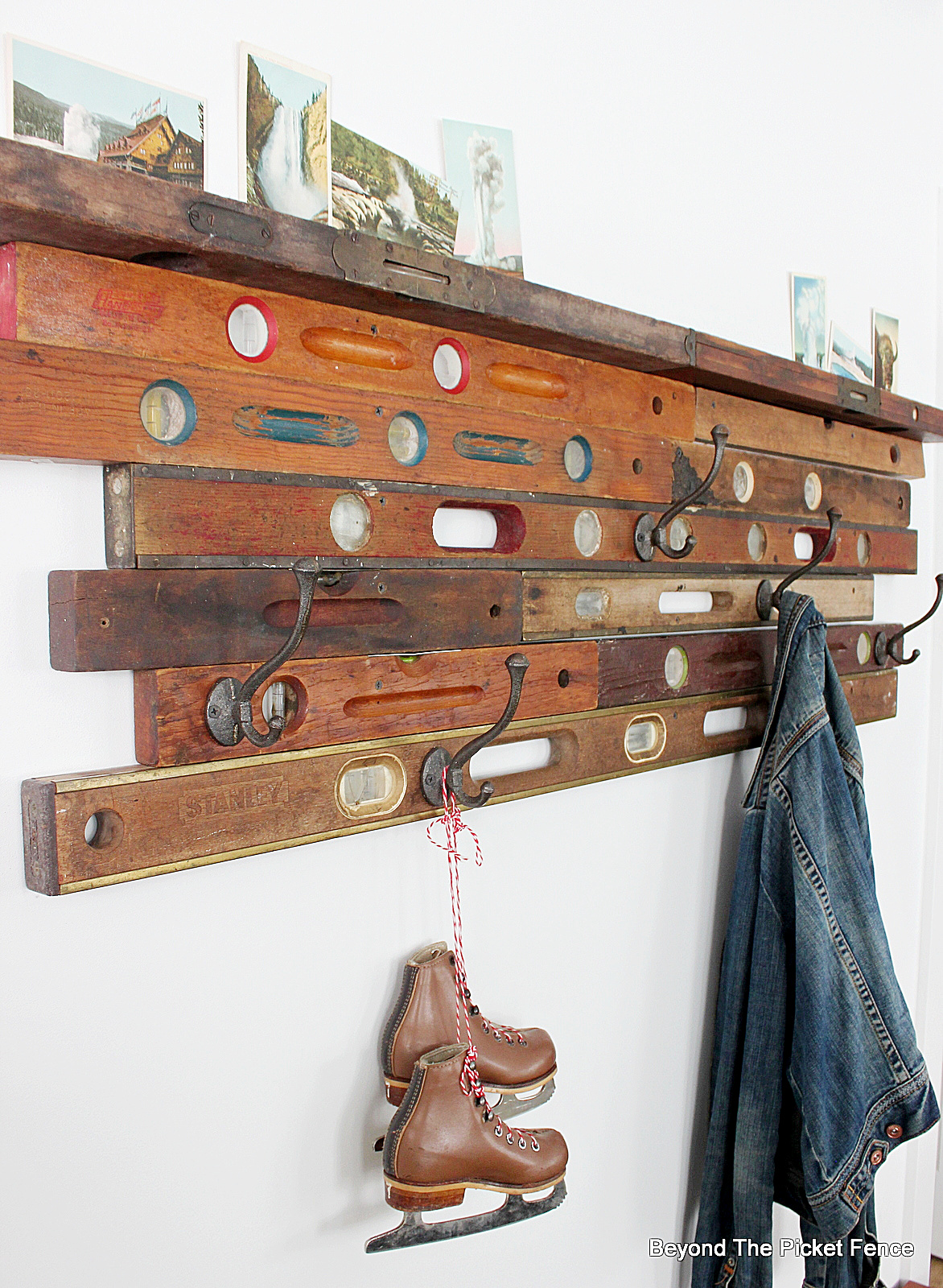 Vintage eclectic coat hooks on old wooden spirit level
