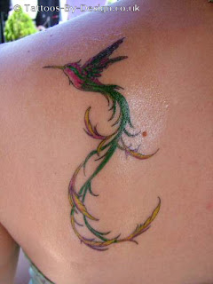 cool humming bird back tattoo