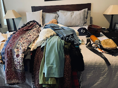 Pile of vintage clothing on a bed