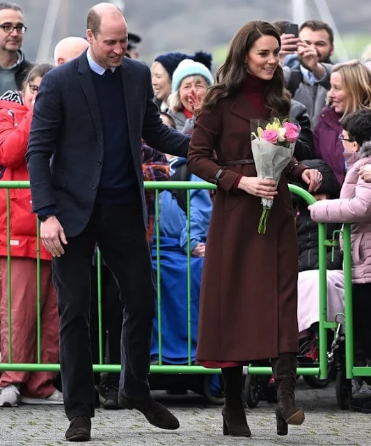 Prince of Wales wore a Celeste wool coat by Hobbs London, and she wore a crimson turtleneck sweater dress