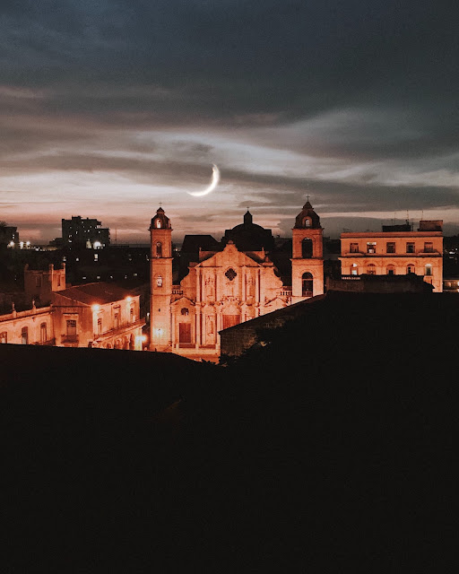 Vista de um telhado para a praça da catedral de Havana, à noite