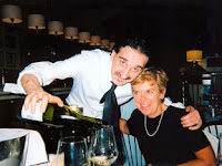 Moreno pouring Nan a glass of vino bianco at La Bussola in Florence