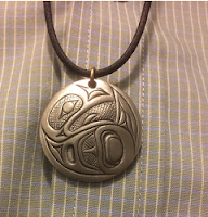 picture of silver pendant depicting a raven, by Alex Helin, artist from Tsimshiam Nation, B.C.