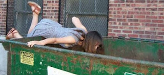 GIRL IN A TRASH DUSTBIN