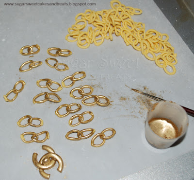 Painting fondant gold chain with edible gold dust to resemble Chanel purse gold strap links.