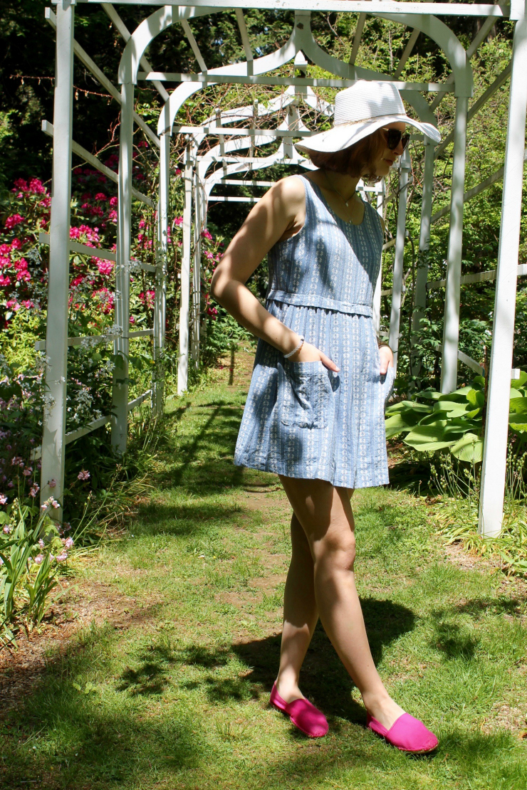 Short blue and white summer dress worn with a large wide rimmed white summer hat