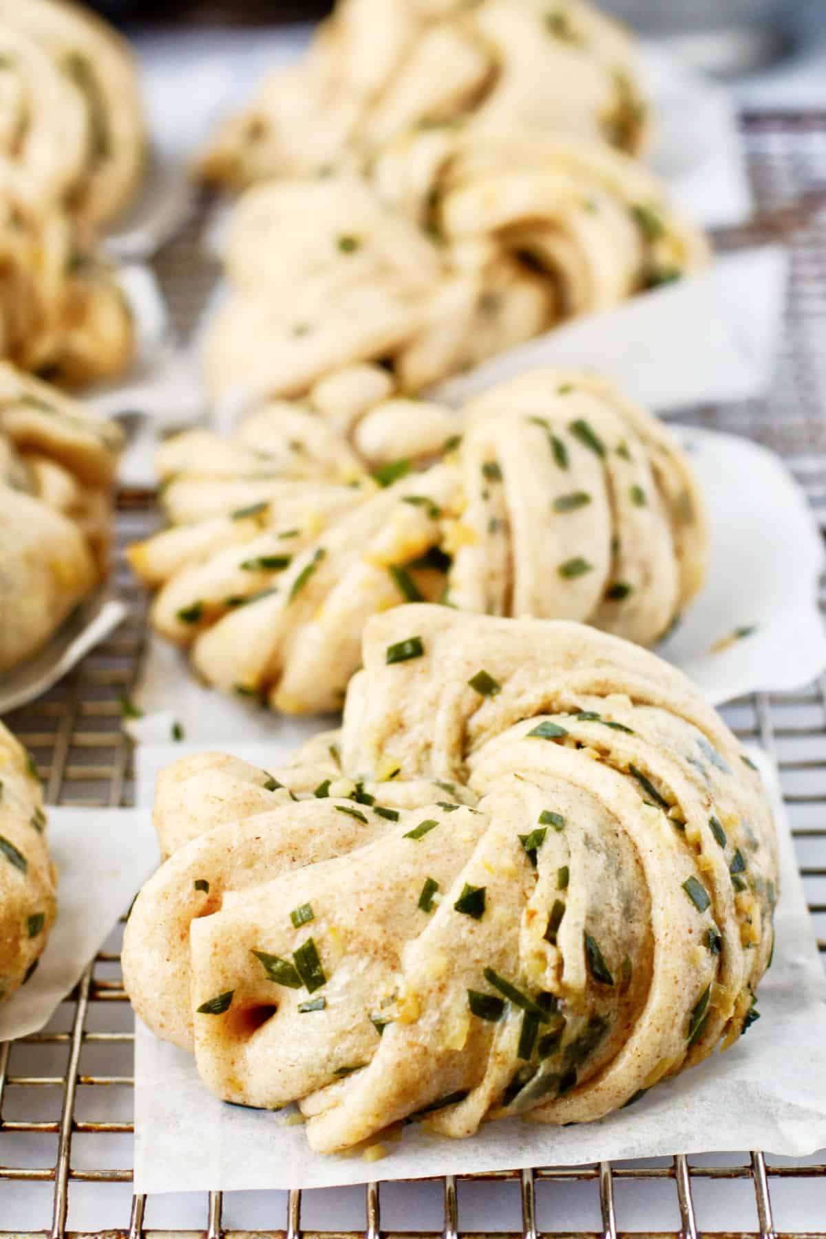 Garlic and Chive Flower Buns on a cooling rack.